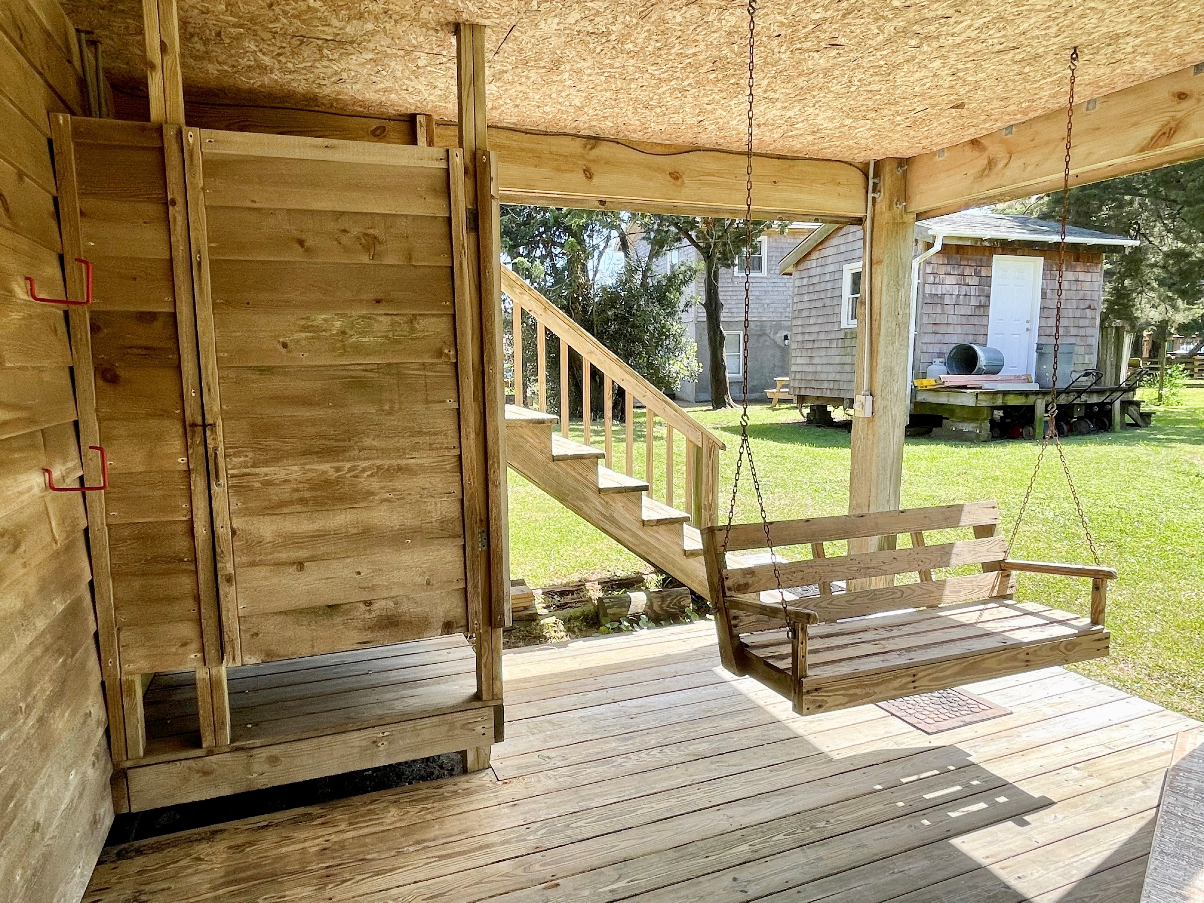 Ground Deck Under House with Outdoor Shower and Swing