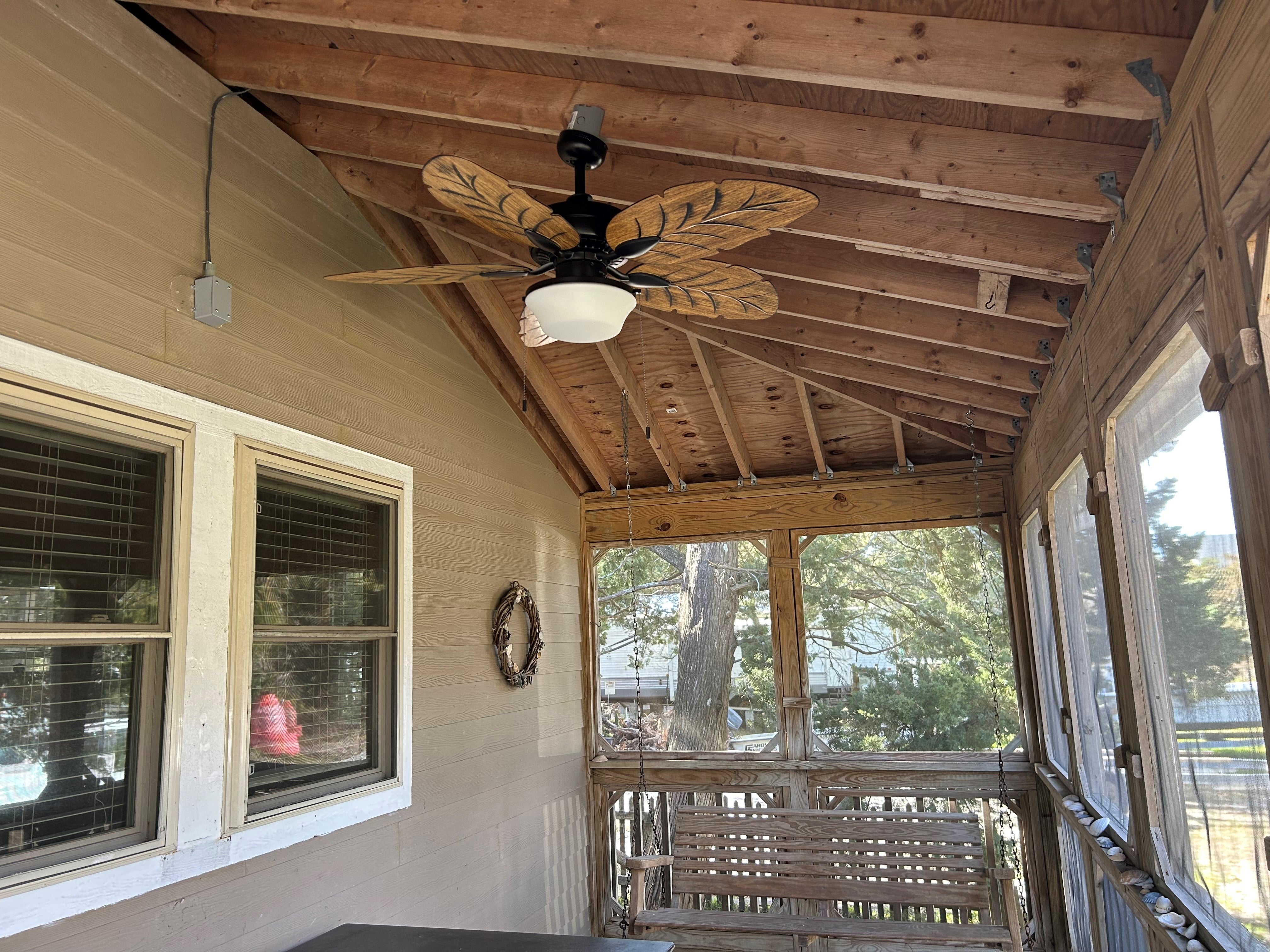 screened in porch with fan