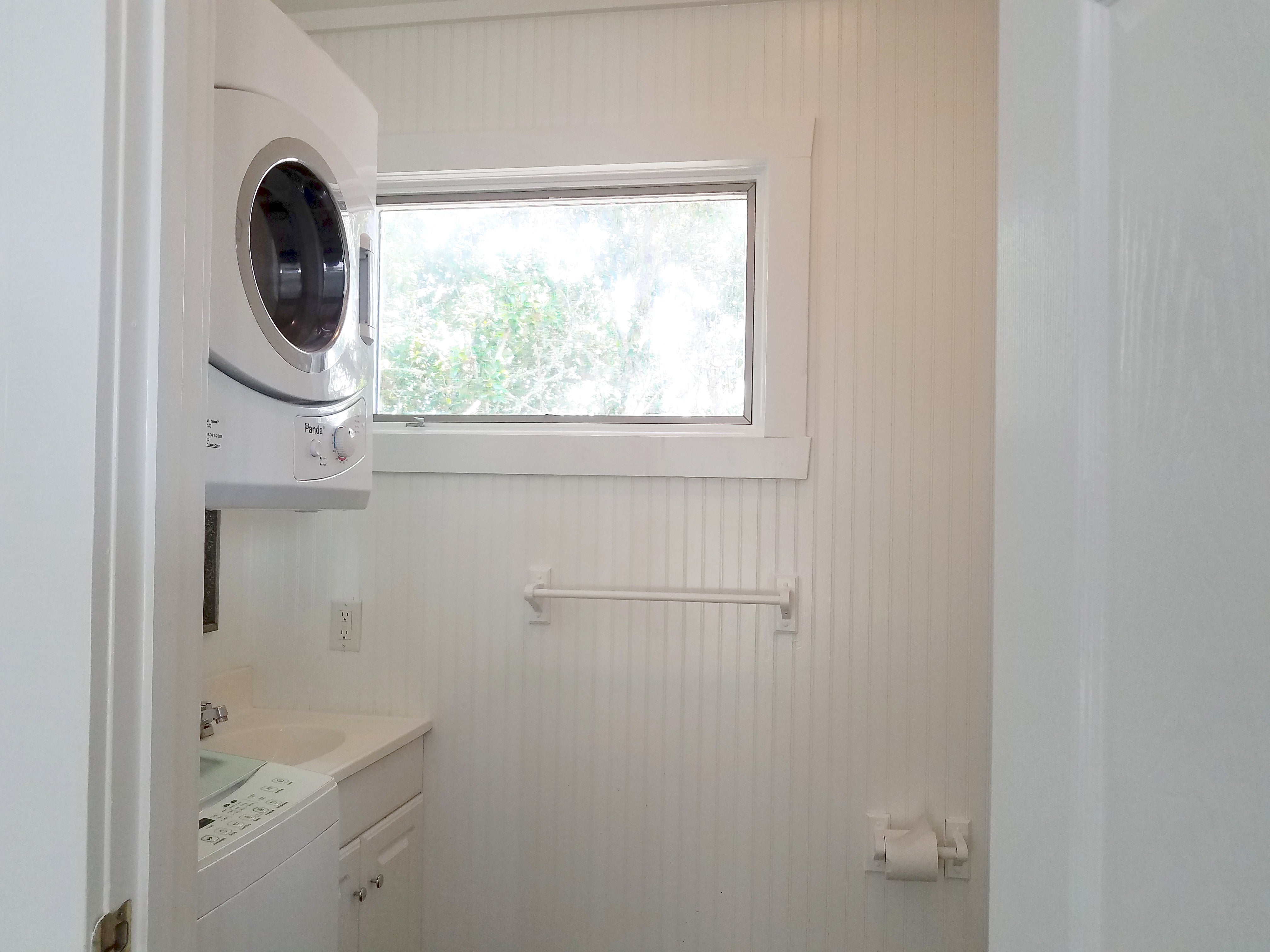 Enclosed Bathroom with Vanity, Toilet, and Stack WasherDryer