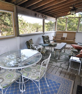 Rear Screened Porch with Seating and Dining Table