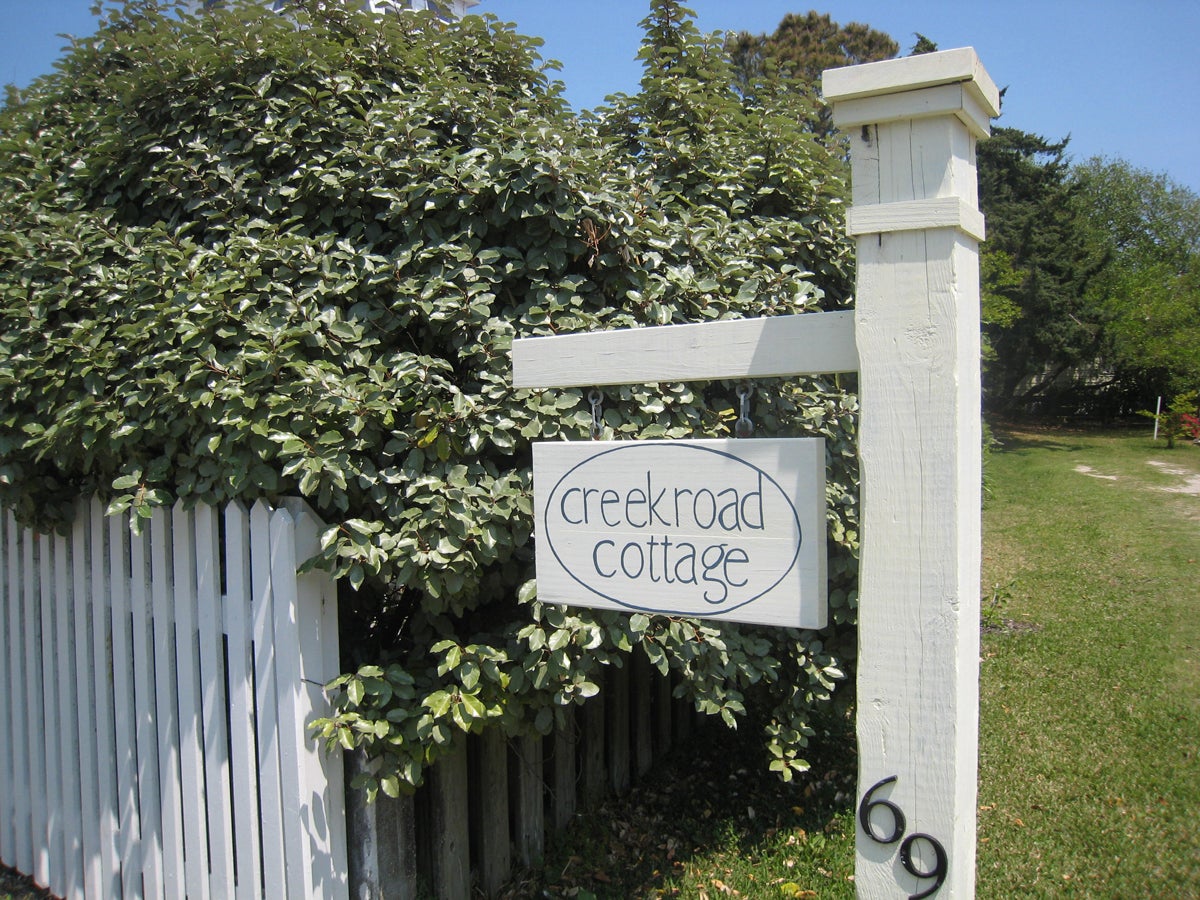 Creek Road Cottage Sign Near Road