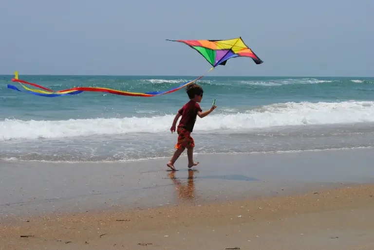 Child with kite on beach