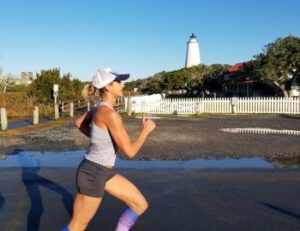 Runner Passing Ocracoke Lighthouse